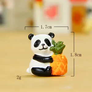 Cute miniature panda holding pineapple figurine detail shot, resin micro landscape bonsai decor.