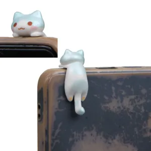 Cute cartoon cat phone dust plug and hanging charm detail view showing cute resin figurine design.