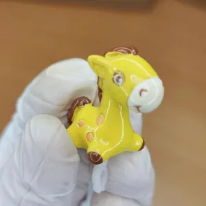 Detailed view of cute cartoon spotted pony 3.5mm headphone jack dust plug DIY accessory.