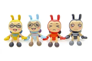 Close-up detail view of four colorful cute bee cartoon figurines with different facial expressions.
