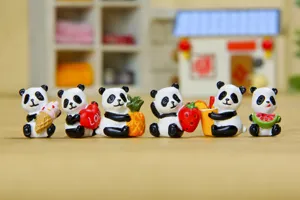 Detailed close-up of cute miniature panda figurines holding food like ice cream and fruit.