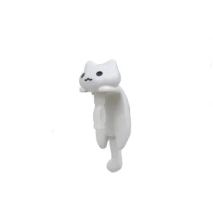 Detailed view of the white cat dust plug detail, showing fine shape and smooth texture.