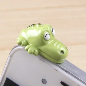 Cute green crocodile cartoon phone dust plug detail, universal 3.5mm jack accessory.