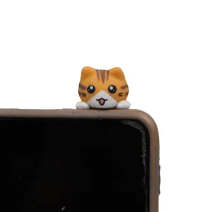 Cute orange tabby cat phone plug detail view, adorable cartoon resin dust plug accessory.