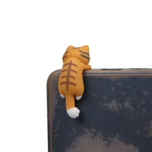 Cute orange cat phone dust plug, adorable hanging kitty figurine accessory for smartphones.