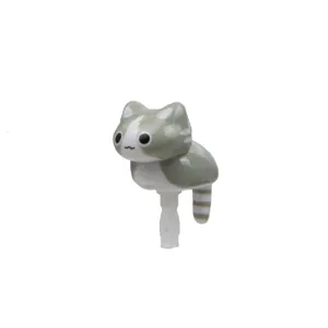 Detailed view of a cute gray and white striped cat phone dust plug, lovely crawling design.