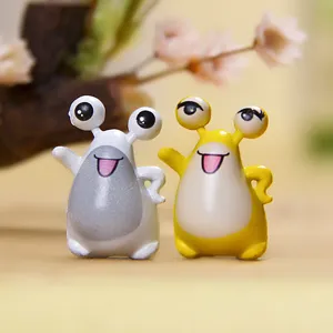 Cute couple big-eyed monster cartoon phone dust plug resin miniature desktop figurine.