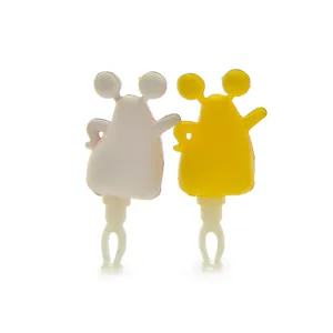 Closeup of cute cartoon monster dust plug, playful couple design for 3.5mm audio jack.