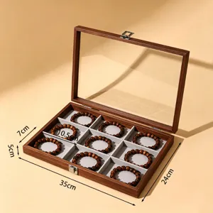 Houten sieradenopbergdoos met glazen deksel, meerdere vakken voor armbanden en horloges.