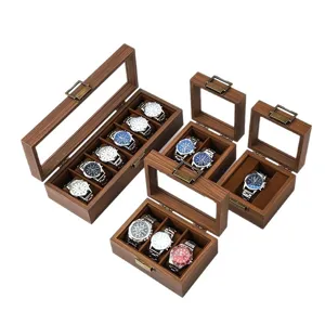 Boîte à montre en bois de noyer avec couvercle en verre transparent et fermoir métallique pour collection.