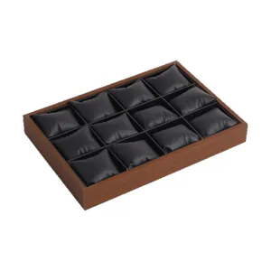 12 slot watch display tray with wood grain frame and black leather pillows for collection.