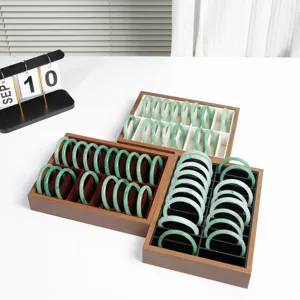 Walnut wooden bracelet tray display set with green jade bangles for live streaming.
