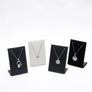Necklace display stands set with black and white holders and stylish pendants for jewelry shop.