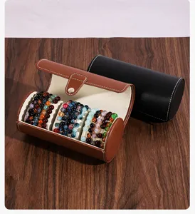 Portable cylindrical jewelry storage box with three slots, PU leather travel watch organizer for bracelets.