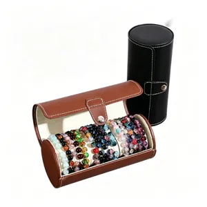 Cylindrical PU leather jewelry storage box with multi-slot organizer for bracelets and beads.