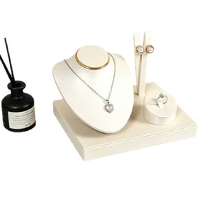 Elegant jewelry display stand set including necklace bust, earring holder, and ring tray for retail.