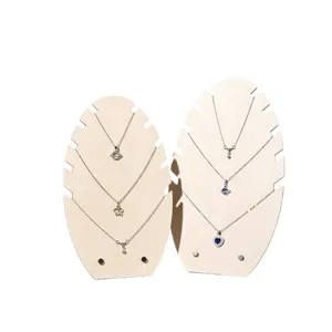 Silver layered necklace set with sparkling pendant on wooden display stand for women jewelry