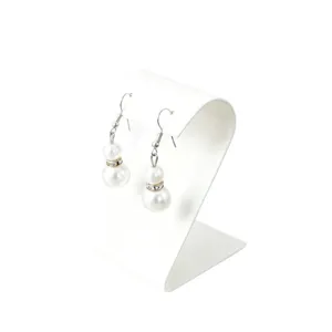 Elegant double pearl dangle earrings with rhinestones displayed on a clean white stand.