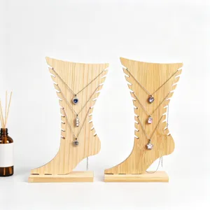 Creative foot-shaped wooden jewelry display stand for necklaces and anklets, photography.