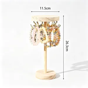 Wooden jewelry display stand with hooks for bracelets and hair ties, natural wood.