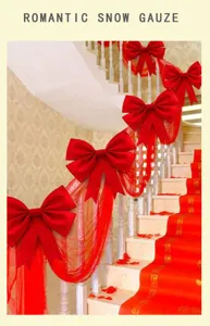 Wedding decorative snow gauze with large red bows for stairs romantic party decor.
