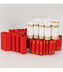 Cintas rojas y blancas con borde dorado en detalle para embalaje floral y decoración.