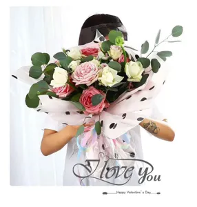 Floral wrapping paper detail showing black polka dot tissue paper for bouquet packaging 70x50cm.