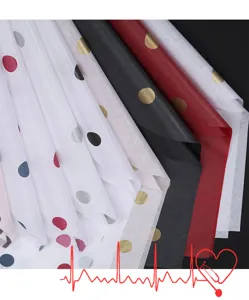 Detailed view of colorful polka dot tissue paper sheets for gift wrapping and floral packaging.