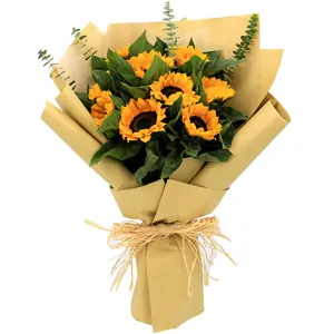 Beautiful sunflower bouquet wrapped in natural kraft paper with eucalyptus leaves.