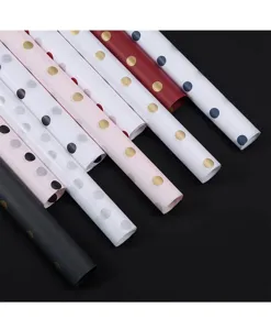 Detailed view of colorful polka dot tissue paper rolls for gift and flower wrapping.