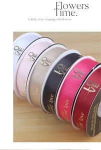 Colorful polyester ribbons with gold foil love print for gift wrapping and floral decoration.