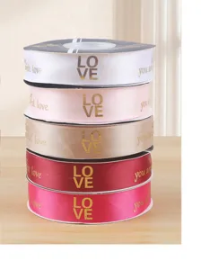 Gold stamped polyester ribbon detail showing stacked colorful gift wrapping ribbons with love text.