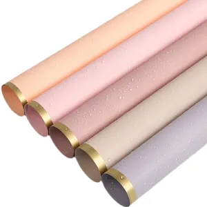 Waterproof floral wrapping paper rolls with gold edge, multi-color bouquet packing material.