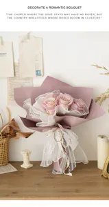 Vue détaillée du filet d'emballage floral en gaze plissée avec bouquet de roses violettes.