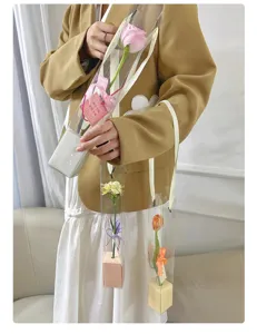 Clear PVC single flower packaging bag with ribbon and handle for romantic gift presentation.