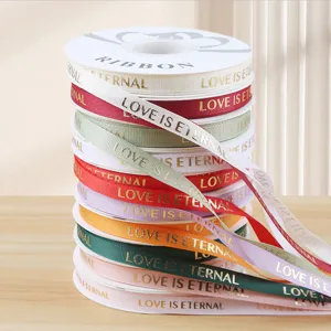 Colorful grosgrain ribbon roll with gold foil print for gift wrapping, floral bouquet and DIY crafts.