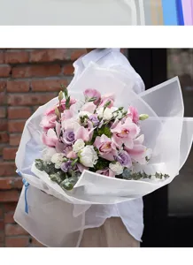 Detailed close-up shot of elegant floral bouquet wrapped in translucent frosted waterproof paper.