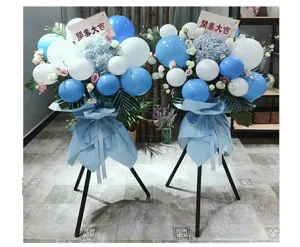 Grand opening balloon floral stand detail showing blue and white balloons with flowers.