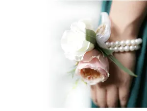 Primer plano detallado del corsé de muñeca de perlas de boda con rosas de tela blanca y rosa.