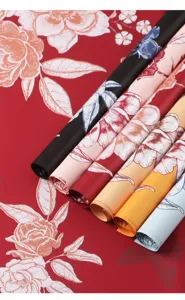 Detail view of waterproof floral wrapping paper rolls with colorful printed flower designs.