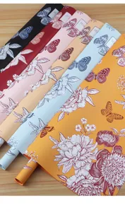 Waterproof flower wrapping paper roll with elegant butterfly and floral print for bouquet packaging.