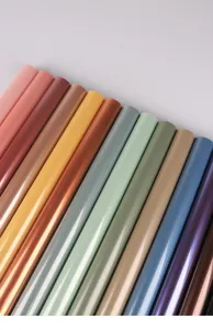 Detailed view of colorful wrapping paper rolls showcasing glossy finish and vibrant shades.