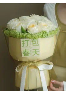 White rose bouquet detail shot, elegant wrapping paper and ribbon, beautiful floral gift.