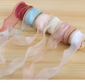 Nastro in organza trasparente con bordo metallizzato dorato, perfetto per regali e mazzi di fiori.