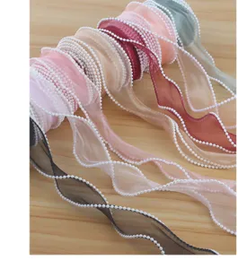 Detailed view of colorful organza ribbon with pearl edge, perfect for DIY gift wrapping crafts.