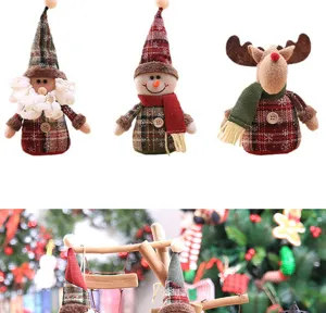 Close-up of three plush Christmas tree ornaments showcasing festive plaid details.