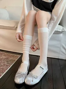 Close-up detail of white ribbed mid-calf socks, breathable mesh style for daily wear.