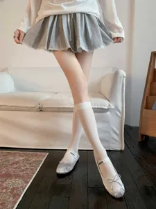 Comfortable white mid-calf socks paired with stylish shoes for women. Perfect spring and summer.