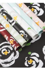 Detailed view of colorful floral wrapping paper rolls with modern brush stroke print designs.