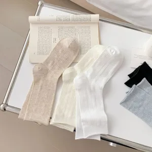 Minimalist solid color ribbed mid-tube women socks, breathable and soft daily wear details.